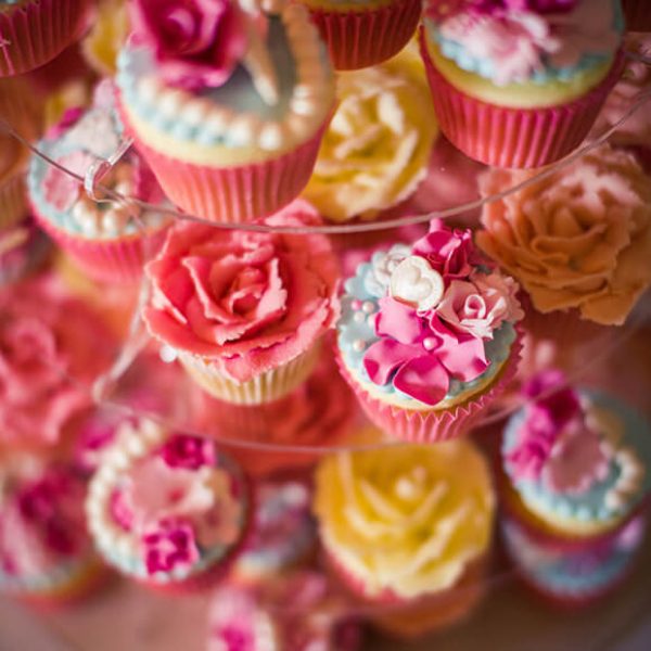 A close up of the couple’s wedding cake which was a tower of pink and yellow cupcakes – wedding ideas