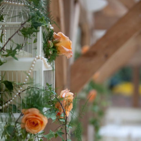 Bird cage filled with flowers as a wedding decoration