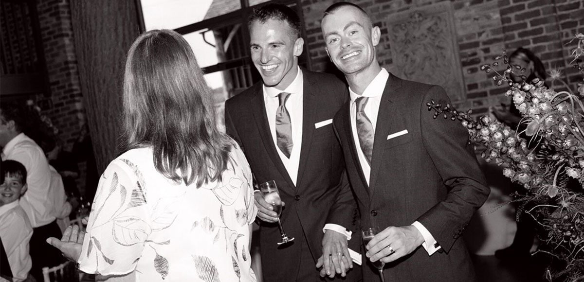 Black and white photo of grooms in their suits – barn weddings Essex