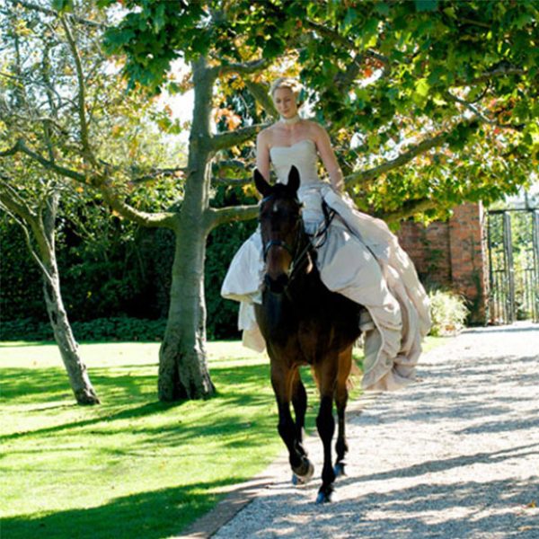 The bride rode down the aisle seated on her horse