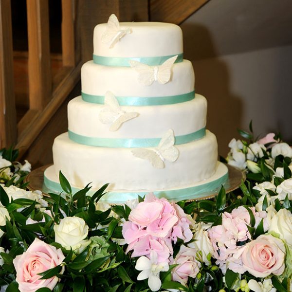 Butterfly wedding cake with flowers as decorations