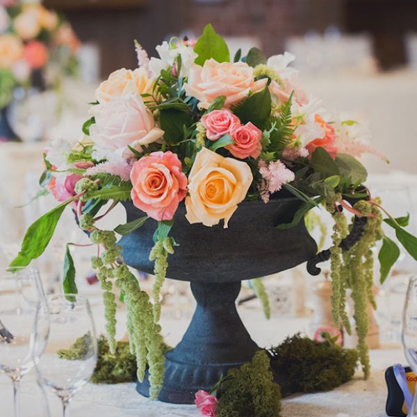 Colourful flower centrepieces for a barn wedding in Essex