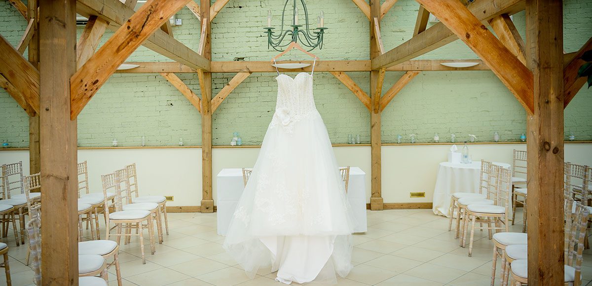 Wedding dress hanging up in the Orangery – wedding venues in Essex