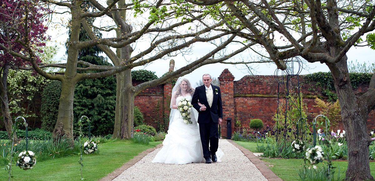 Bride walking down the Long Walk with her father – venues in essex