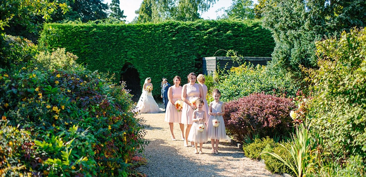 The bridal party get ready for the long walk down the garden aisle at Gaynes Park