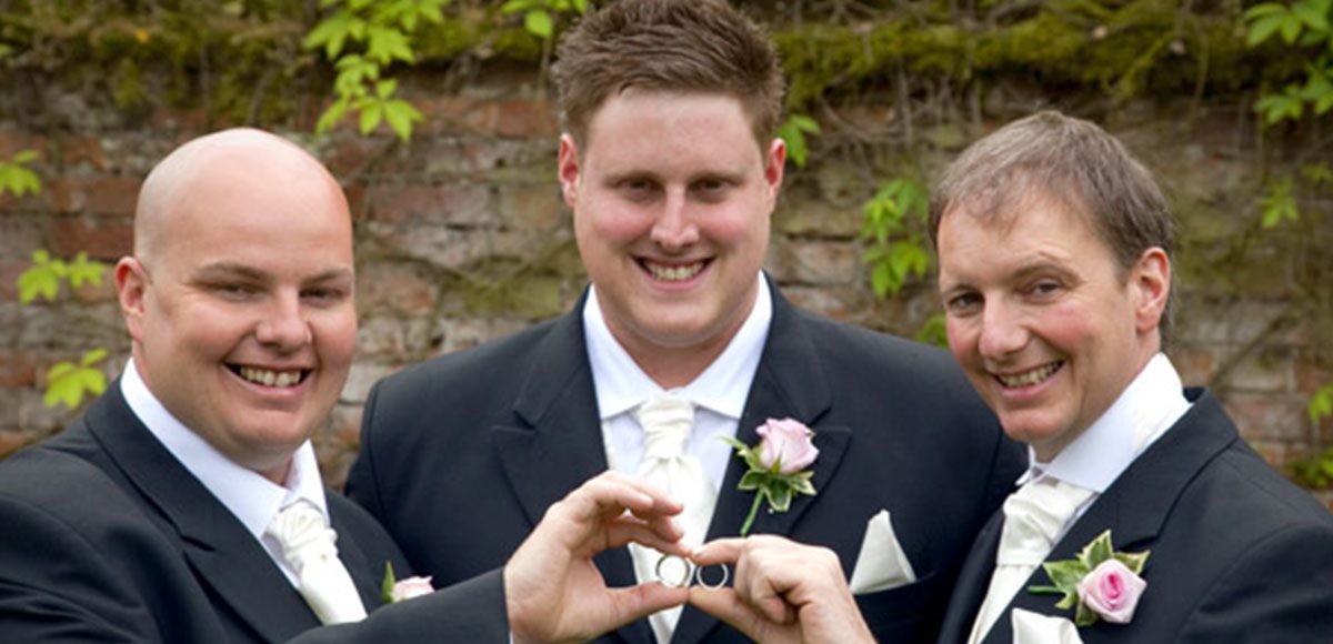 Groomsmen posing with the wedding rings