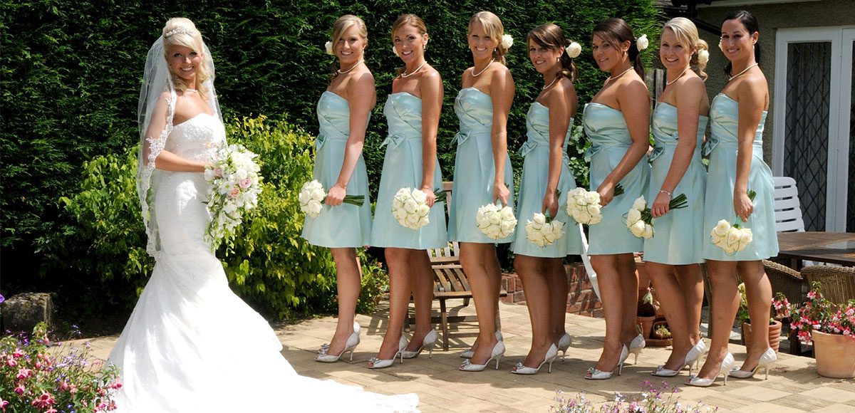 Bridesmaids in summer dresses with the bride
