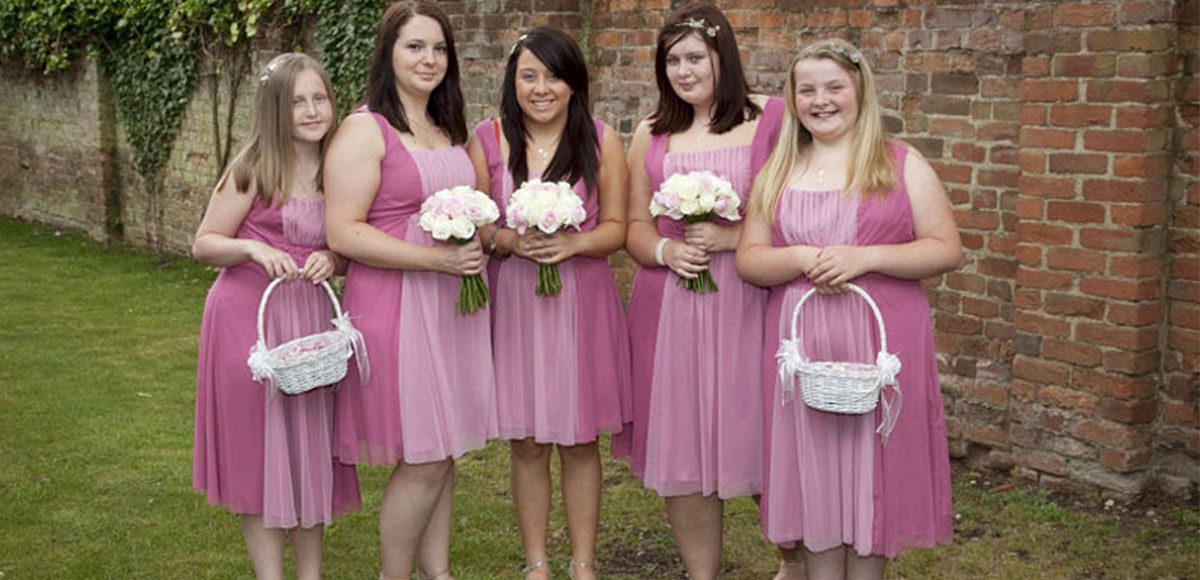 Bridesmaids in pink wedding dresses ready for a reception