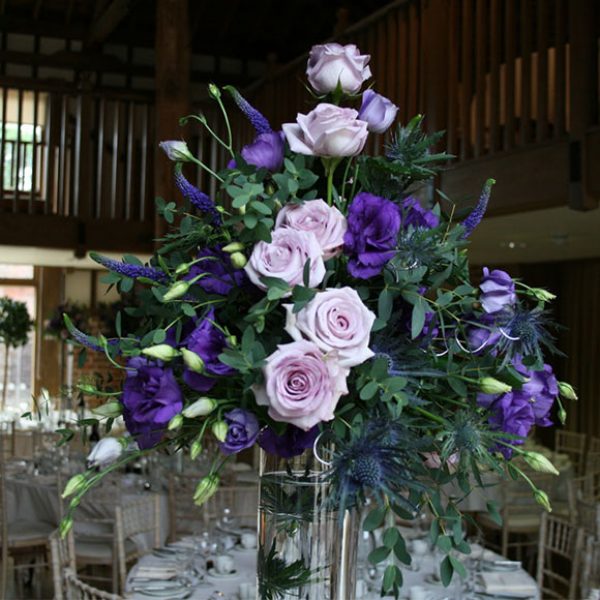 Purple and lilac flowers as wedding centrepieces – barn hire Essex