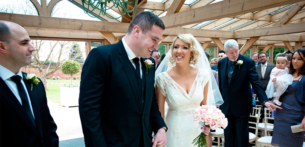 Bride and groom during their wedding ceremony at Gaynes Park in Essex