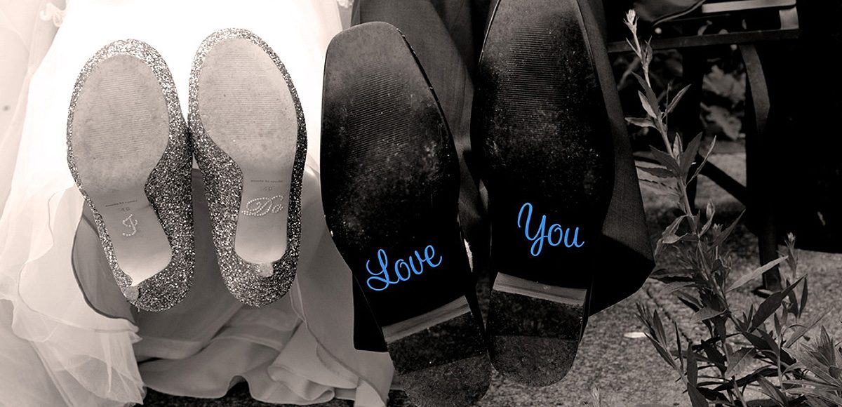 Cute decal details on the bottom of the bride’s and groom’s wedding shoes