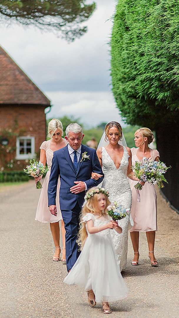 A bride and her bridesmaids leave the Apple Loft Cottage - wedding venues in Essex