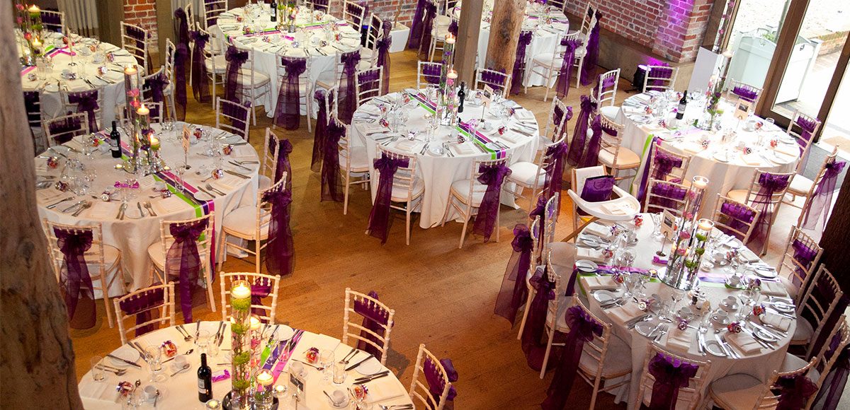 Mill Barn at Gaynes Park dressed in purple decorations – wedding barns Essex