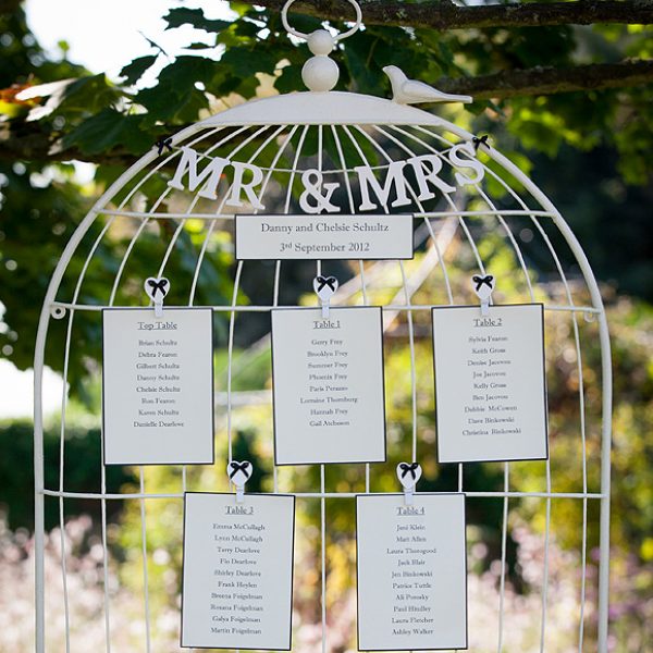 An ivory and black birdcage wedding table plan