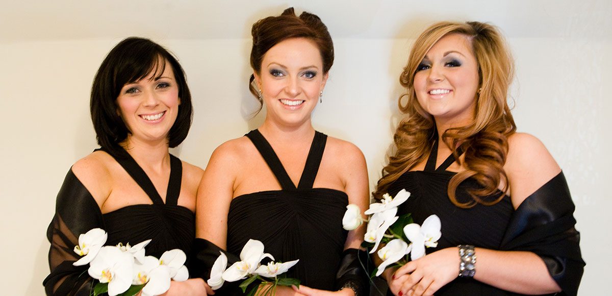 Bridesmaids in black dresses ready for a Winter wedding