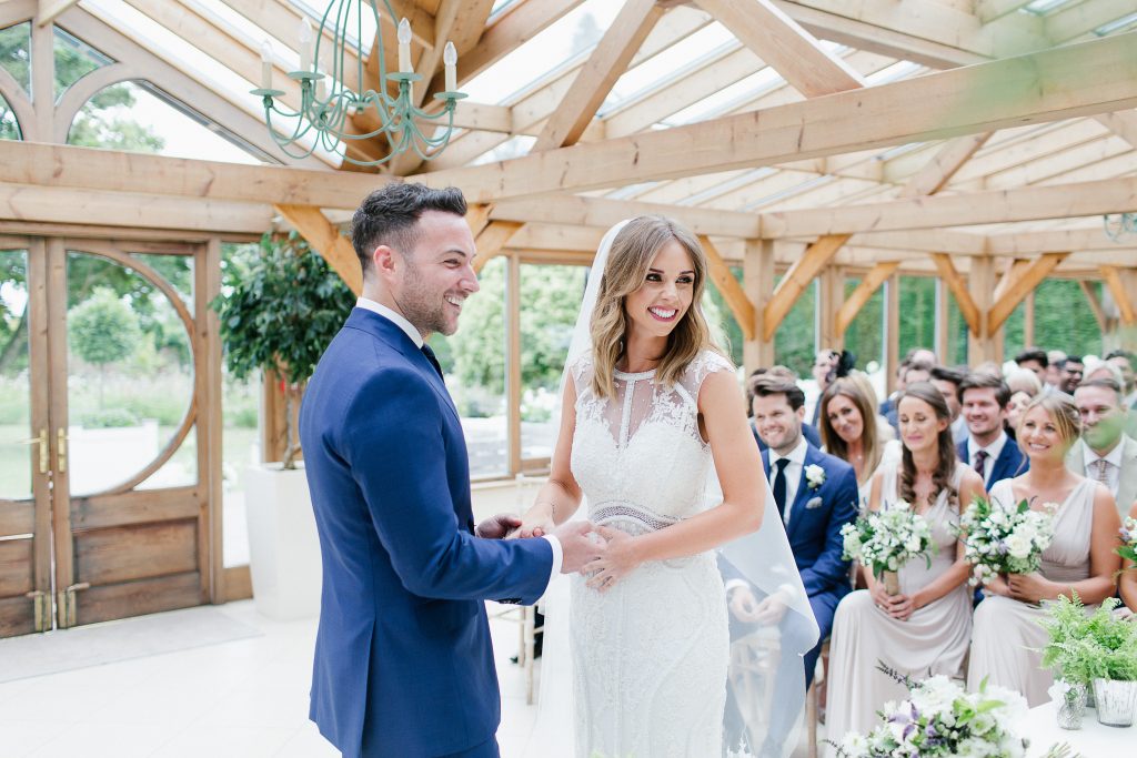 brideandgroomholdhandsweddingceremony Gaynes Park