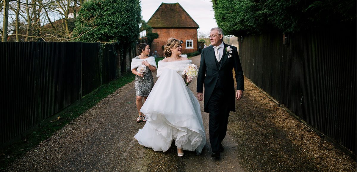 Bride walking with her father at Gaynes Park.