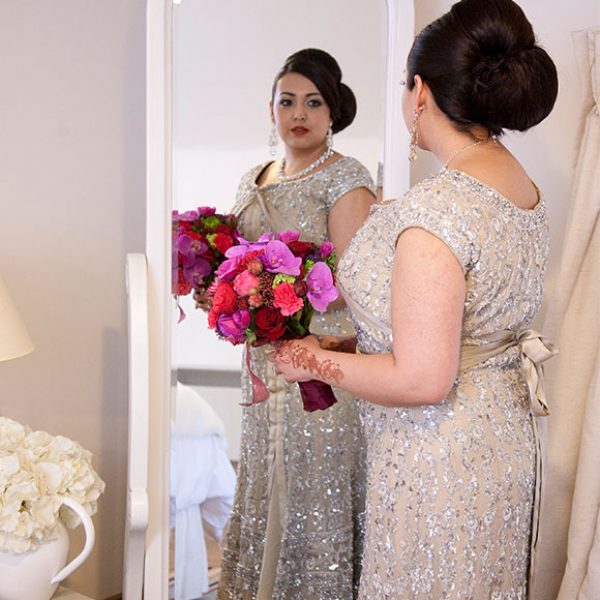 Bride looking in the mirror at her embellished wedding dress