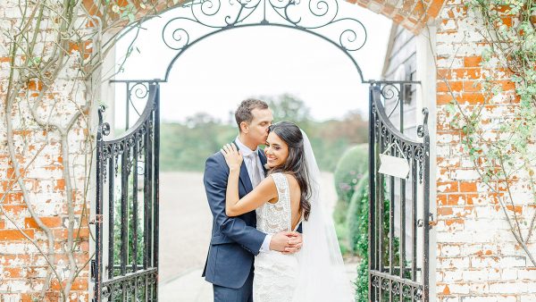 A groom kisses his bride in a special moment at this beautiful wedding venue in Essex - garden wedding