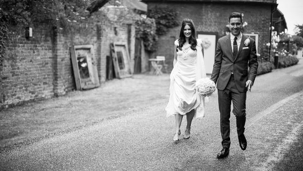 A happy couple enjoy a walk in the grounds of one of the finest wedding venues in Essex
