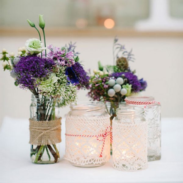 Jars used as vases for flower decorations for a Gaynes Park wedding.