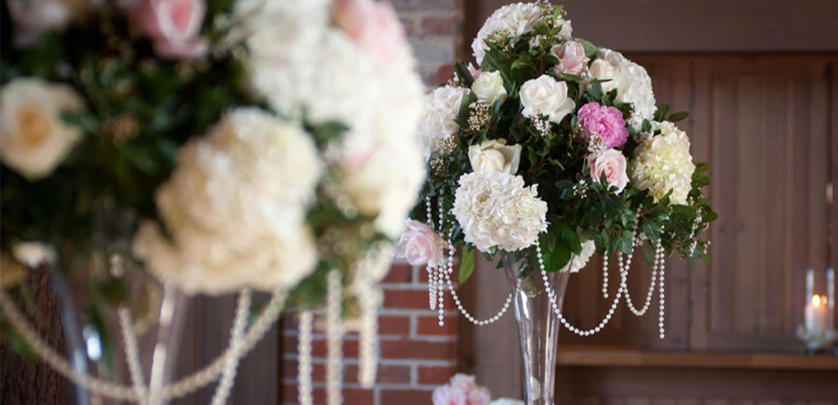 Flowers as centrepiece in the Mill Barn – wedding barns Essex