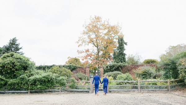 A happy couple make their way to the Long Walk wedding aisle lined with colourful flowers