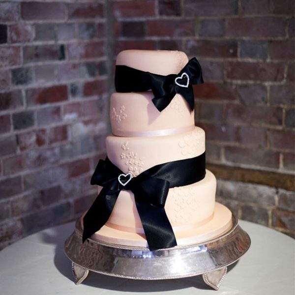 White wedding cake with black ribbon for a wedding reception in Essex.