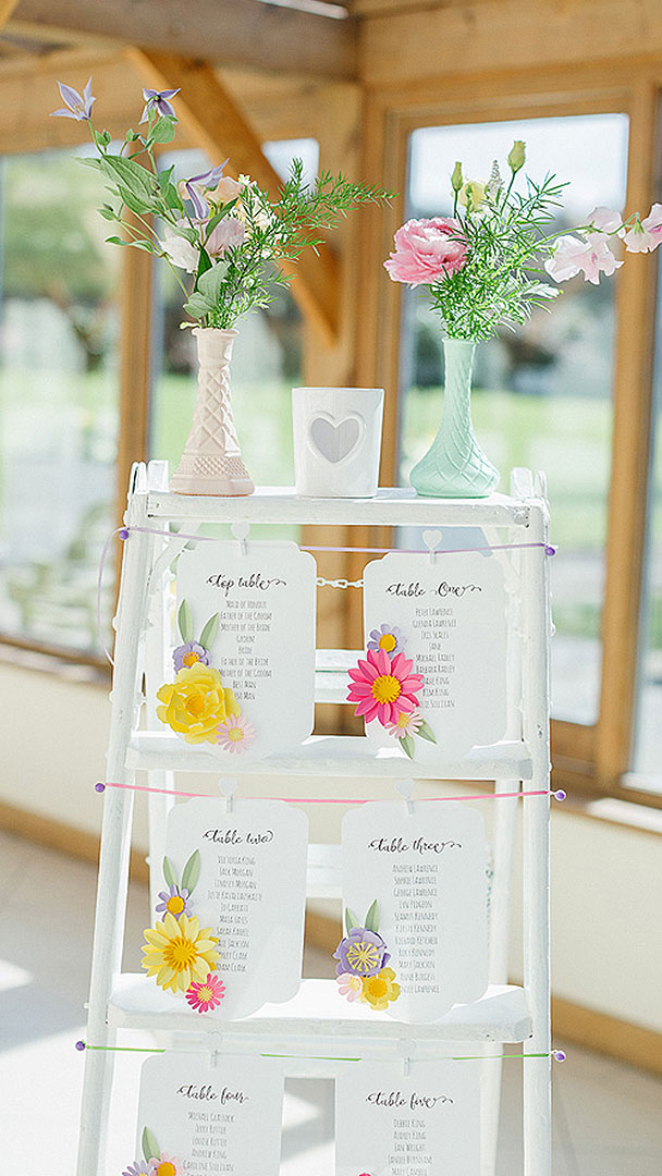 A white wooden ladder is used for the couple's table plan - wedding ideas for a summer wedding