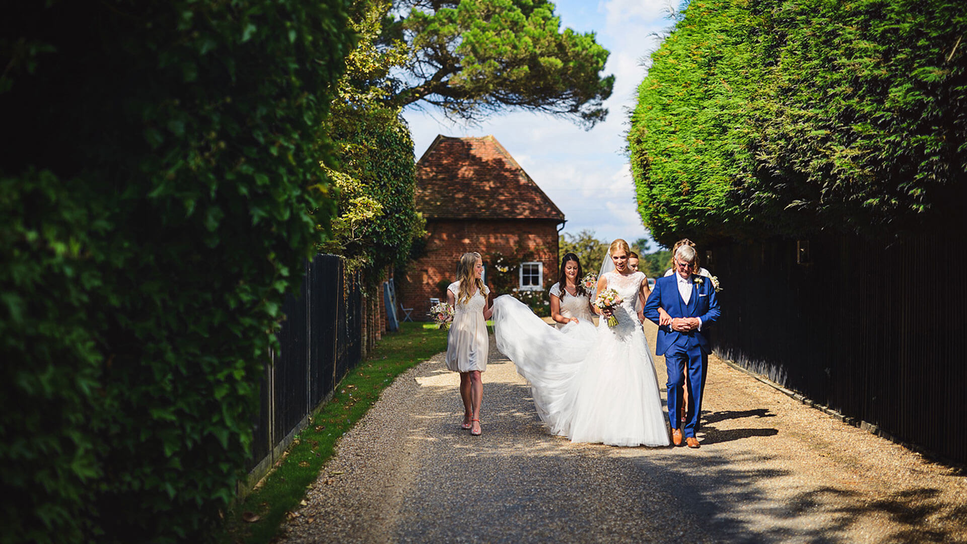 A stunning bride leaves the Apple Loft Cottage and walks to the Orangery to say her marriage vows