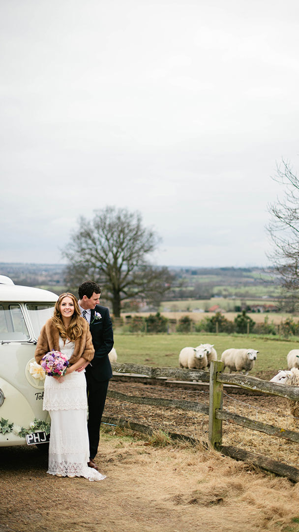 A bride and groom take in the countryside setting for a romantic winter wedding
