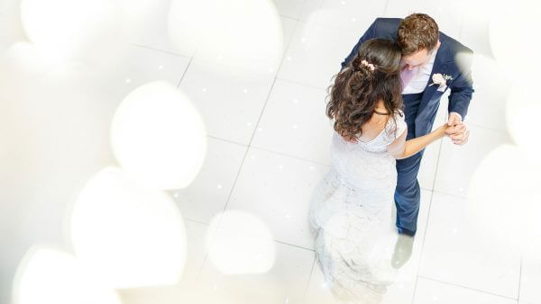 A happy couple enjoys their first wedding dance in the Mill Barn - barn wedding venues in Essex