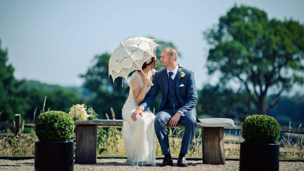 A bride holds a vintage wedding parasol as the perfect accessory for a summer wedding - wedding ideas