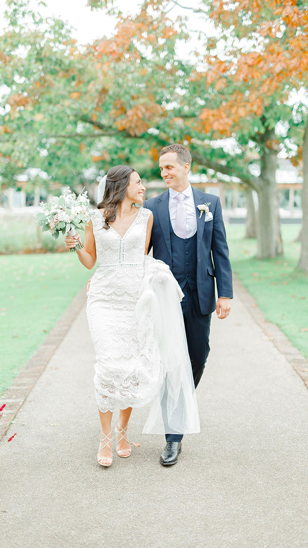 A bride and groom enjoy a moment together along the Long Walk after their wedding ceremony