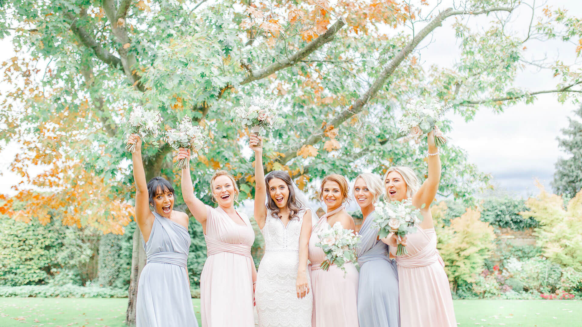 Bridesmaids dressed in pastel shades of pink and lilac - autumn wedding ideas