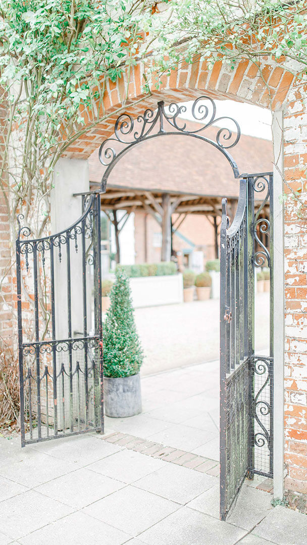Couples can make their way through the iron gate from their wedding ceremony and into the wedding barn