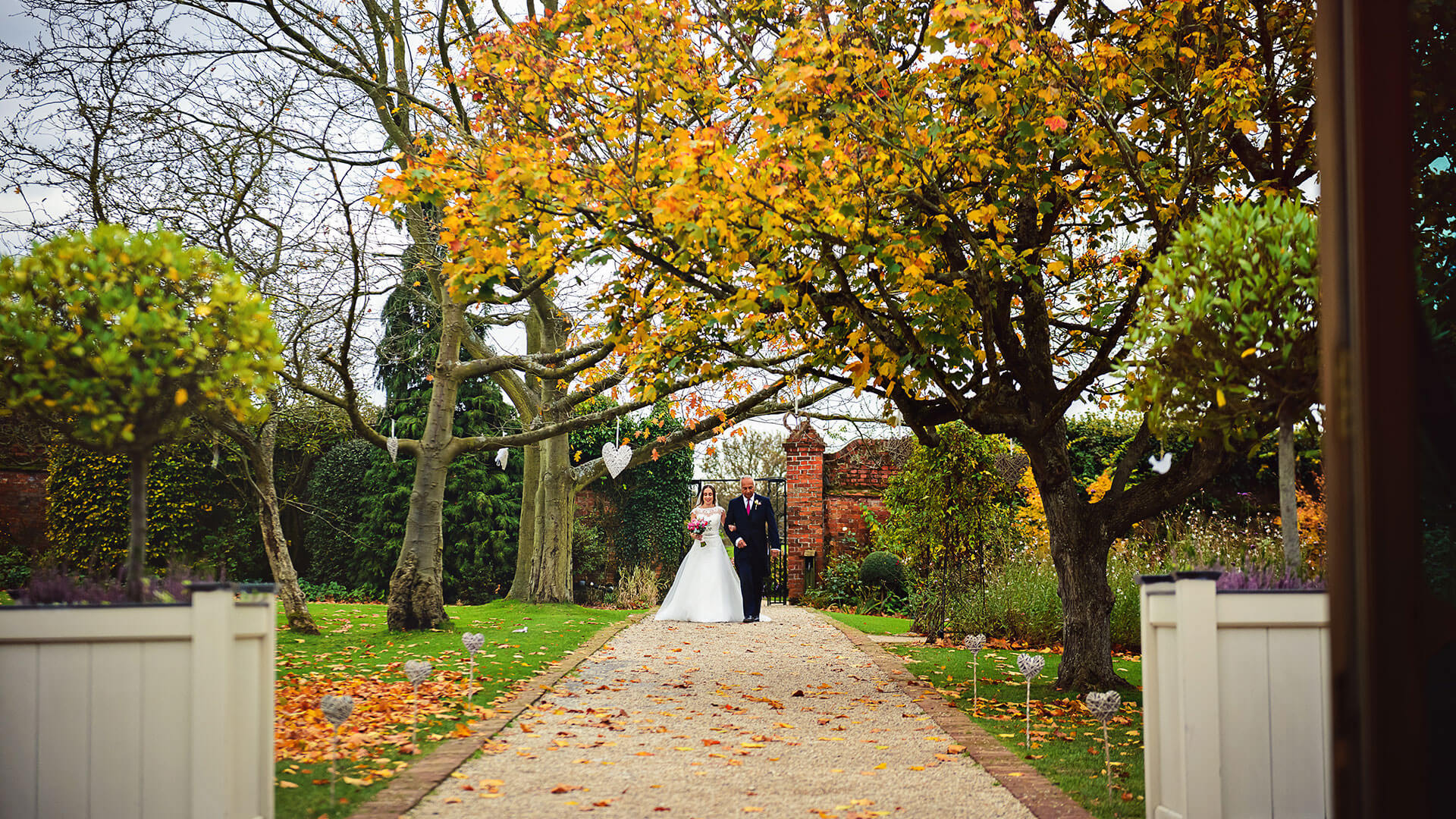 The gardens look beautiful in autumn as the leaves turn brown and begin to fall - autumn wedding