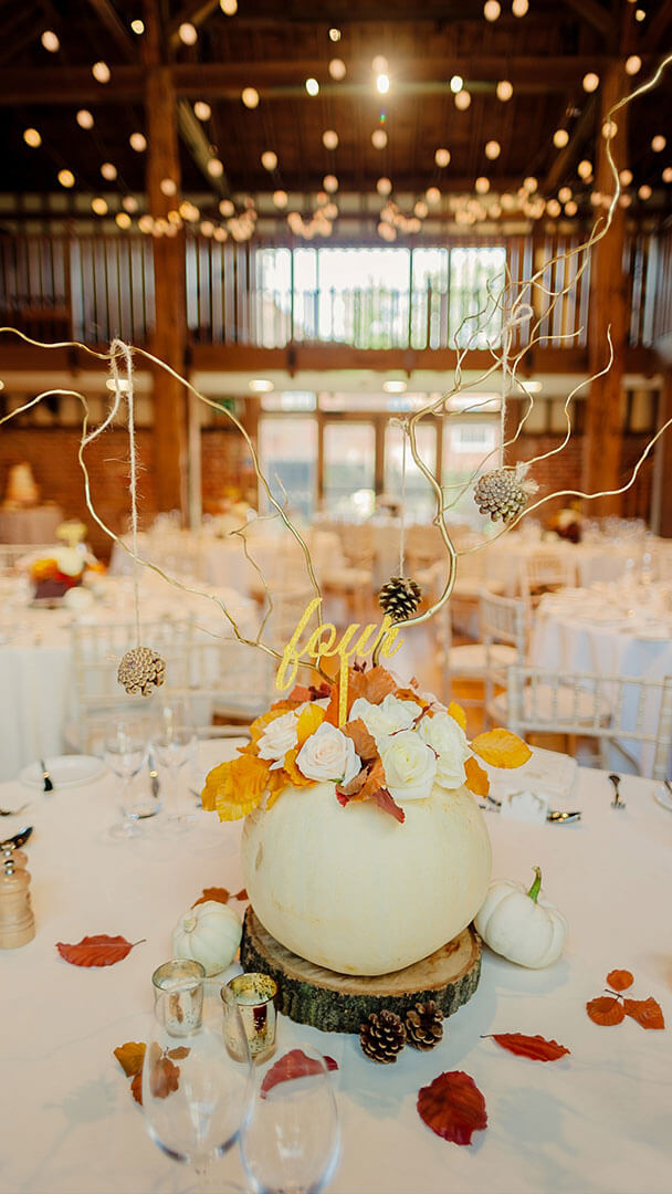 A white pumpkin table centrepiece looks fabulous for an autumn themed wedding