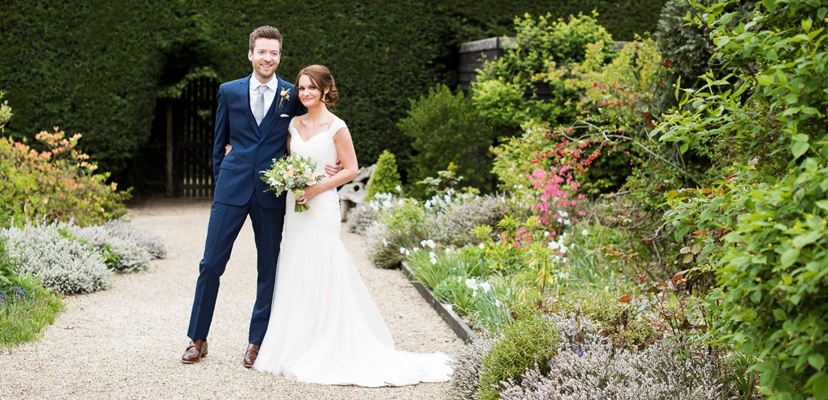 Bride and groom in the gardens of Gaynes Park – Essex wedding venues