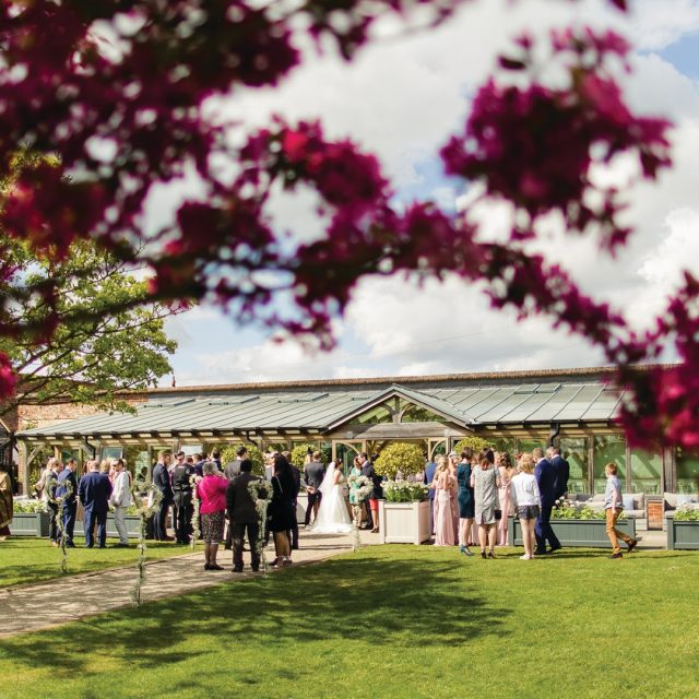 Family gather outside of the Orangery at Gaynes Park