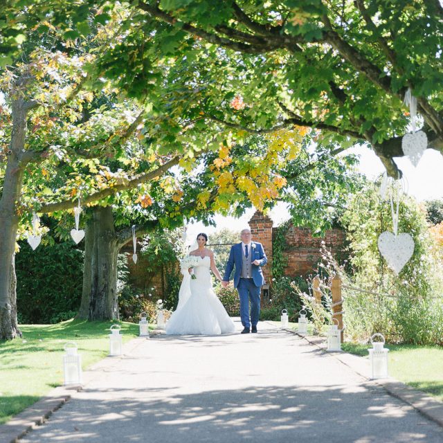 Bride and Groom enjoying the gardens at Gaynes Park, Essex