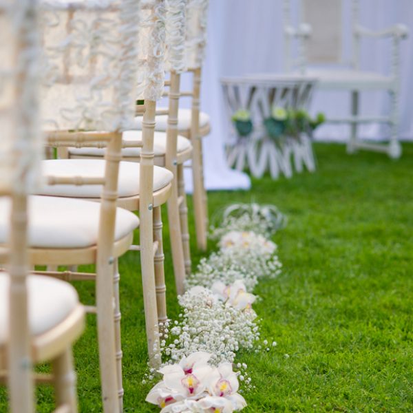 Gypsophila combined with other white flowers looks pretty laid on the grass and lining the outdoor wedding aisle