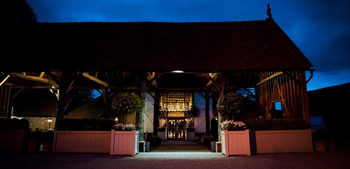 The Gather Barn at Gaynes Park in Essex looks stunning in the evening and is a perfect place for wedding guests to take a moment away from the dancefloor
