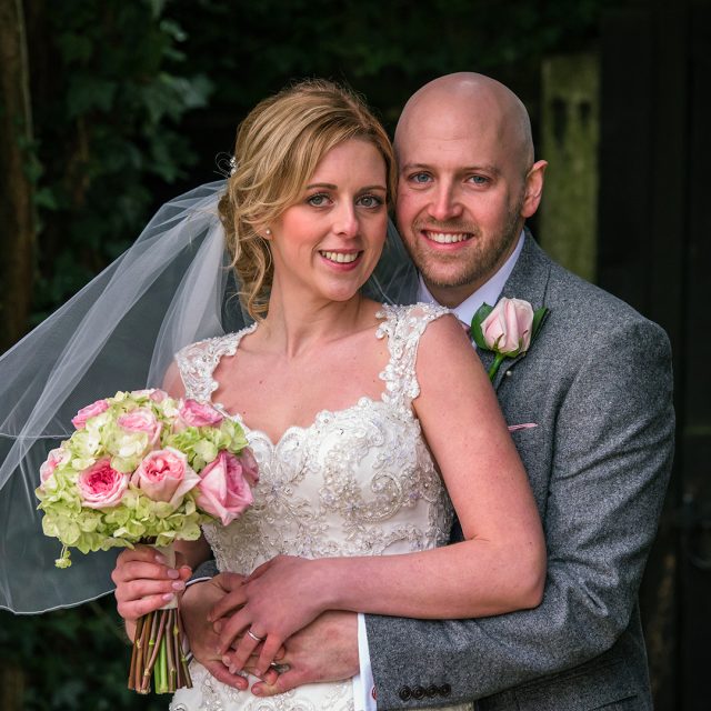 The bride and groom take a moment away from guests to enjoy the gardens at Gaynes Park