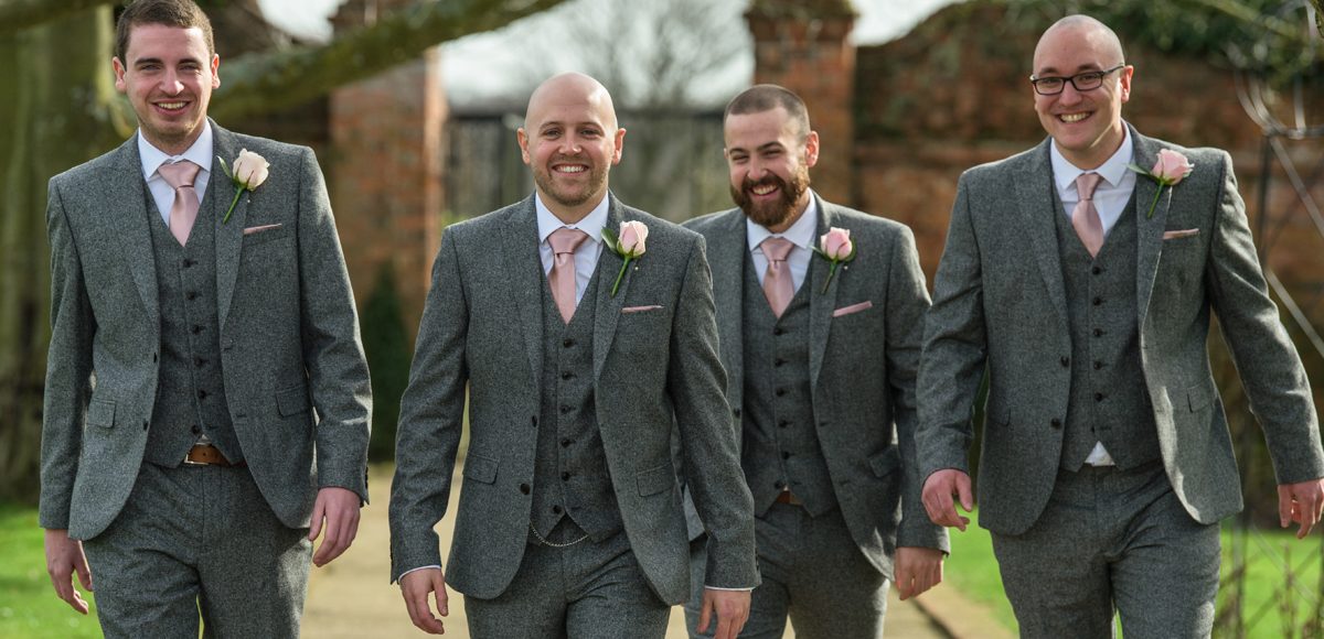 The groom and his ushers walk down The Long Walk ready for the wedding ceremony at Gaynes Park