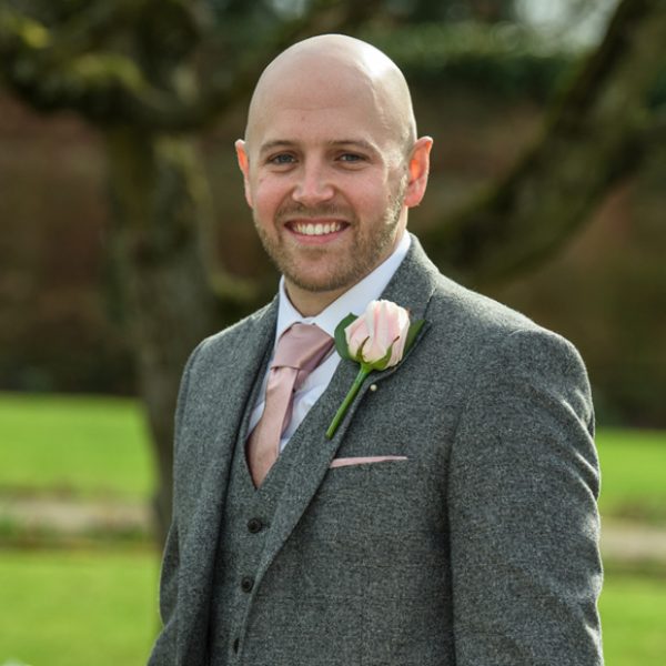 The groom wore a grey suit with blush pink tie for the natural spring wedding at Gaynes Park in Essex