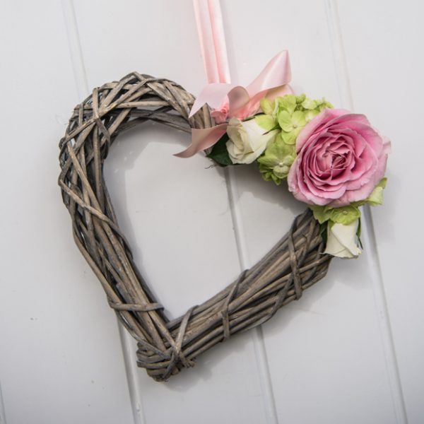 The Essex wedding venue was decorated with wicker hearts for a rustic wedding feel