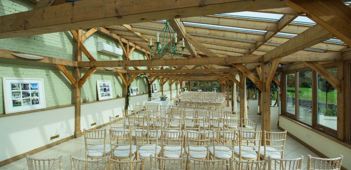 The Orangery at the Essex wedding venue is set up for a spring wedding ceremony
