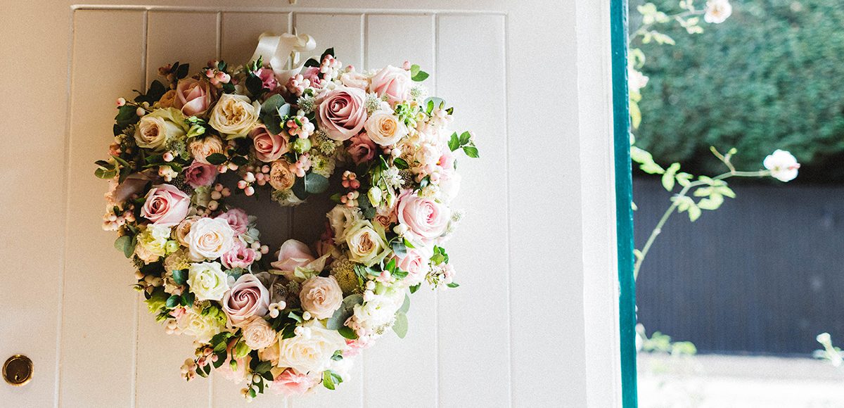 A heart is made up of beautiful pink roses for a vintage wedding look