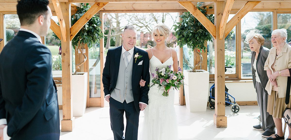The bride was glowing as she entered the Orangery at Gaynes Park for the wedding ceremony